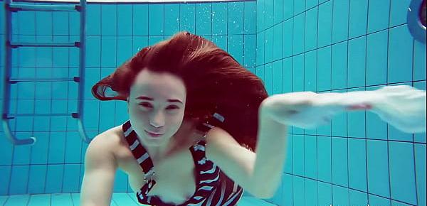  Cute hairy pussy teenie Nina in the swimming pool